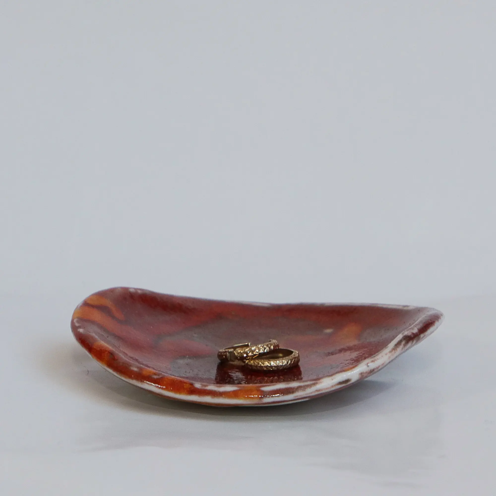 Nahaufnahme Kleine runde dunkelrote orange Schmuck Schale Deko Kunst Keramik Weichporzellan